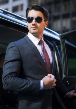 chauffeur standing with car